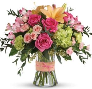 Beautiful bouquet of pink roses, pale pink spray roses, green hydrangea, and yellow lilies