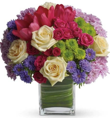 Oh, what a fine day it will be when you have this delightful spring bouquet delivered to someone special. Everyone will delight in the vibrant colors and bountiful blossoms, all thoughtfully arranged in a beautiful leaf-lined vase.